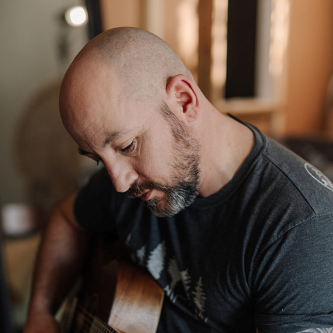Picture of a man holding a guitar.