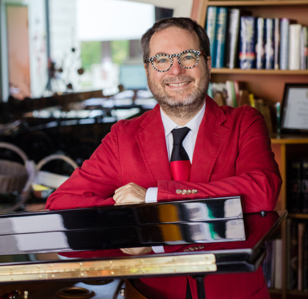 Picture of a man behind a piano.